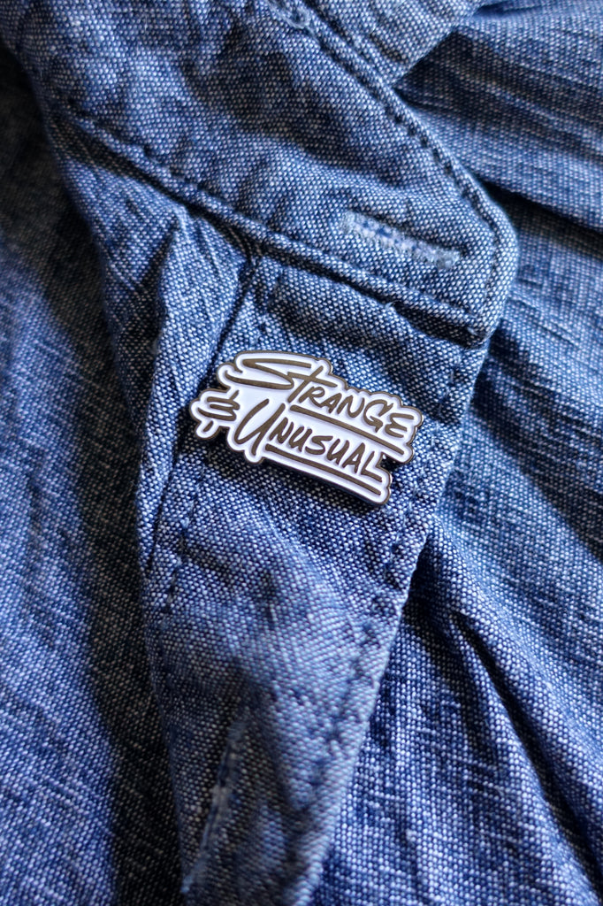 Strange and Unusual Enamel Pin