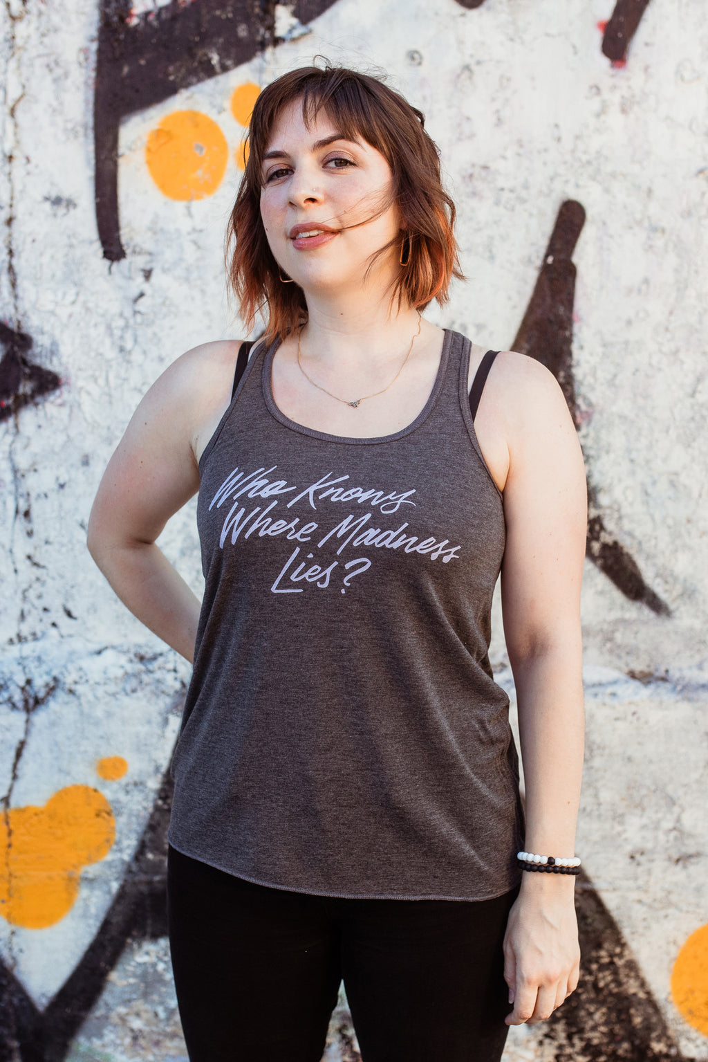Where Madness Lies Fitted Flowy Racerback Tank | Don Quixote